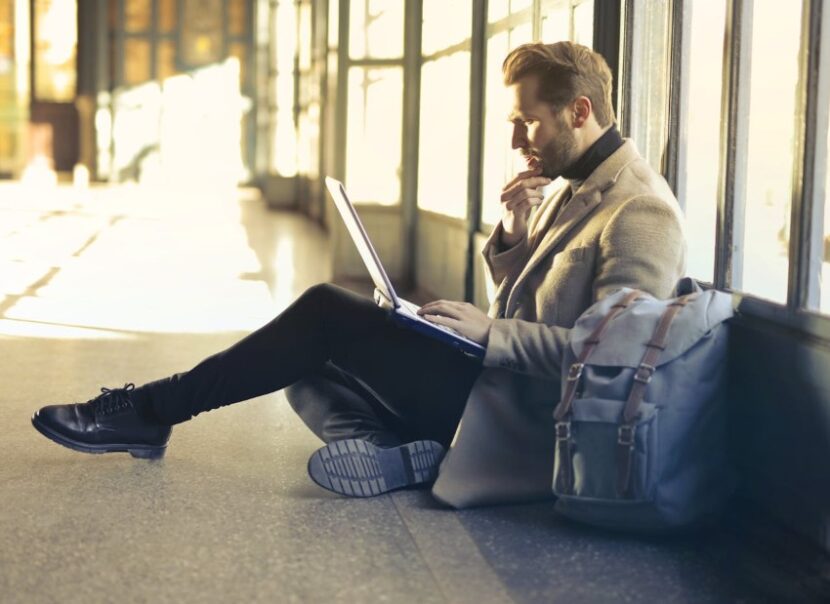 man-using-laptop-airport-830x604 Unexpected Events on Holiday: How to Stay Calm, Prepared, and Confident