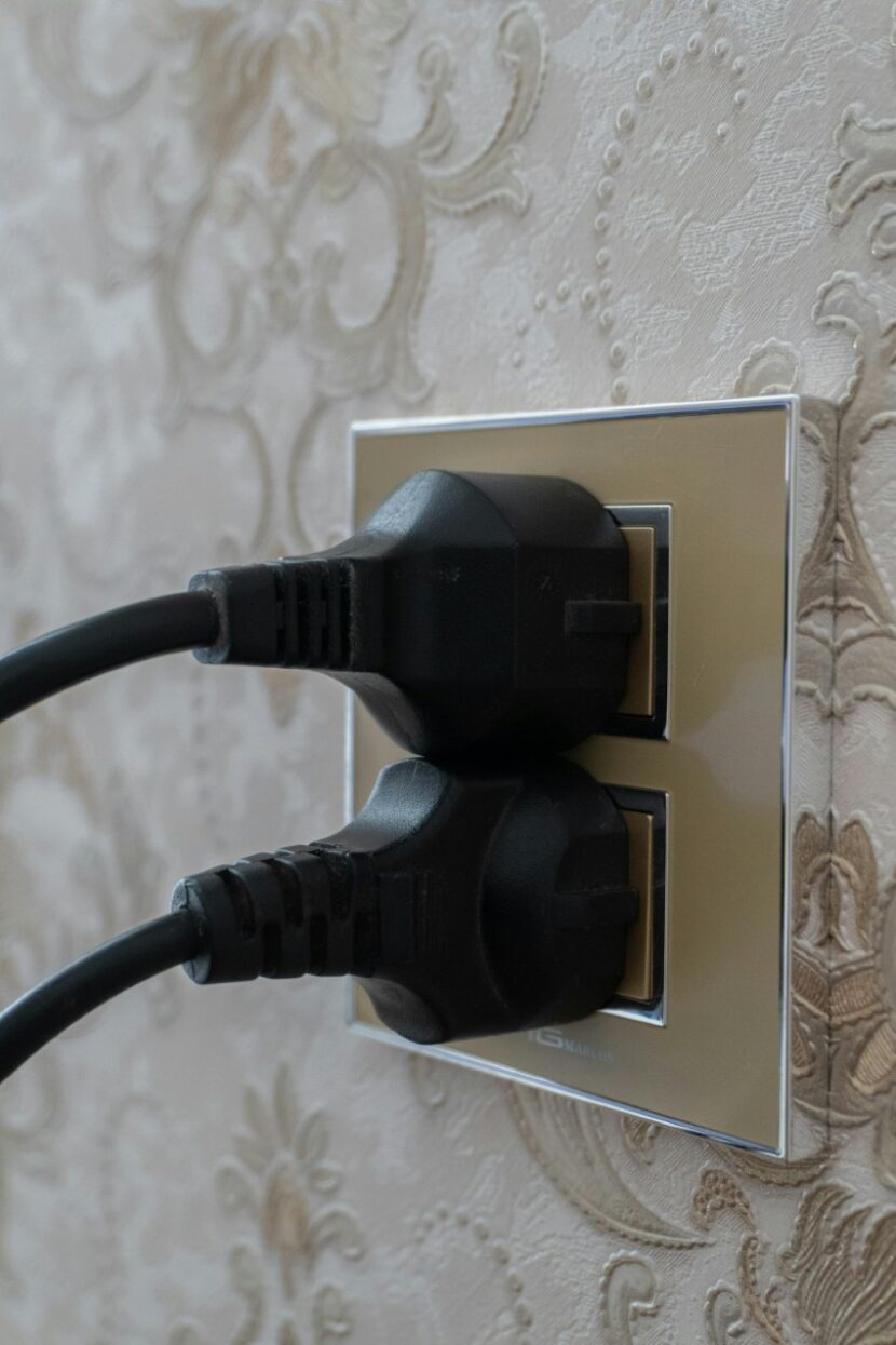 electrical-plugs-wall-socket-830x1245 Is Your Dallas Home's Electrical System Hiding Dangers?
